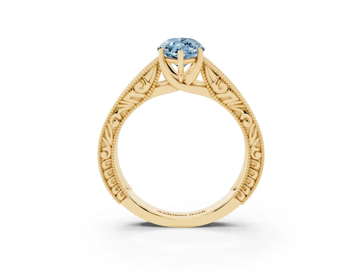Fancy Blue Marquise Cut Diamond Solitaire Ring with Engraved Band and Four-Prong Setting Yellow gold