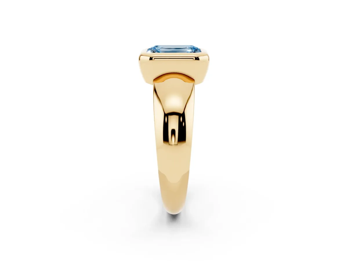 Fancy Blue Bezel Set Emerald Cut Solitaire Ring with Wide Band Yellow gold