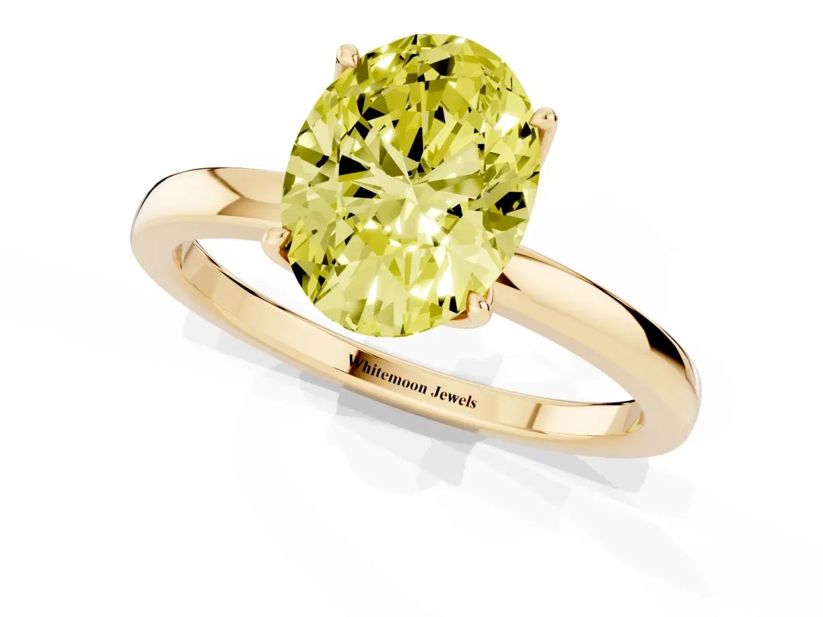 Fancy Yellow Oval Cut Diamond Solitaire Ring with Thin Band and Prong Setting Yellow gold