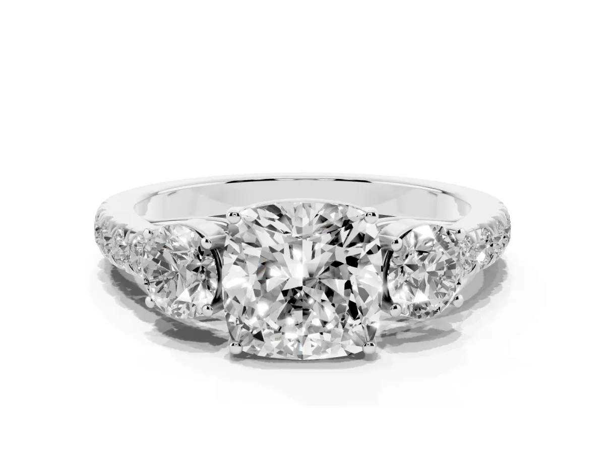 Cushion Cut Cut Diamond Three-Stone Ring with Round Side Stones and Pavé Band Platinum