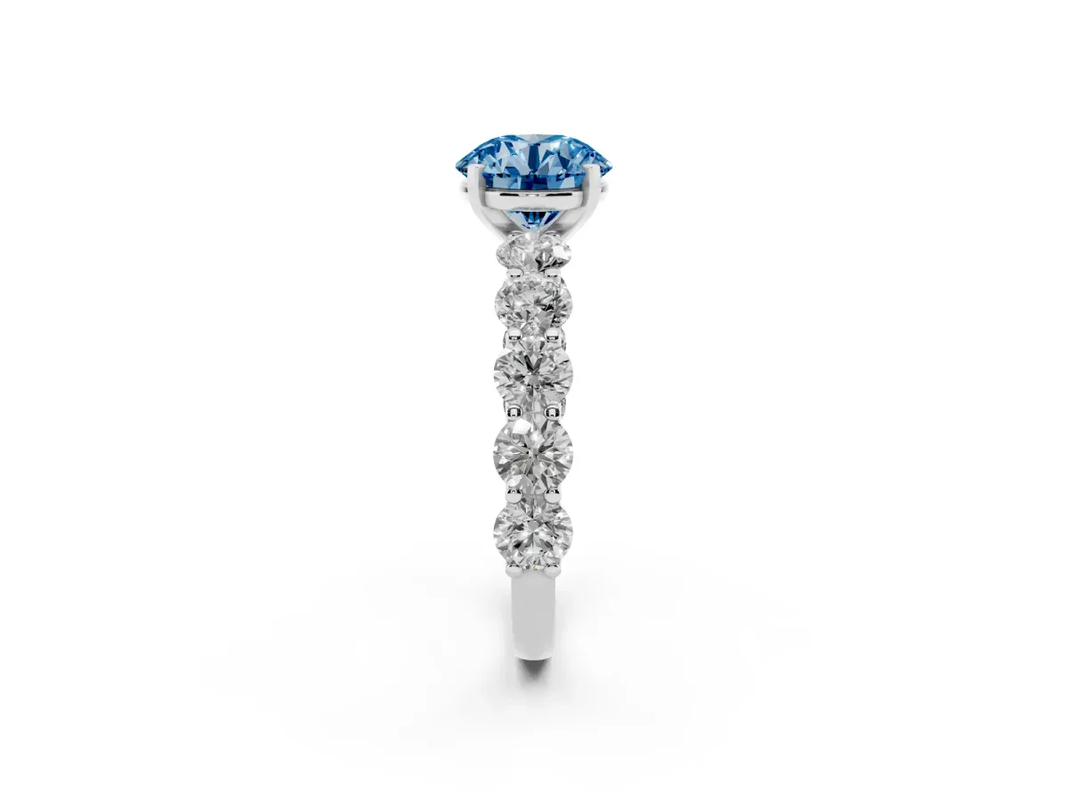 Fancy Blue Round Cut Diamond Prong Setting with Side Stones on a Pave Band Silver
