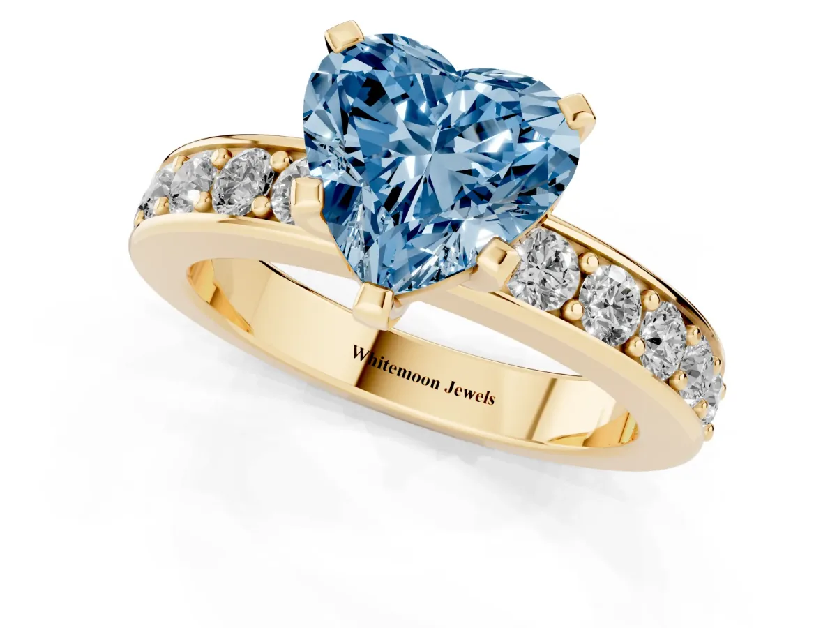 Fancy Blue Heart Cut Diamond Engagement Ring with Channel Set Round Band and Prong Setting Yellow gold