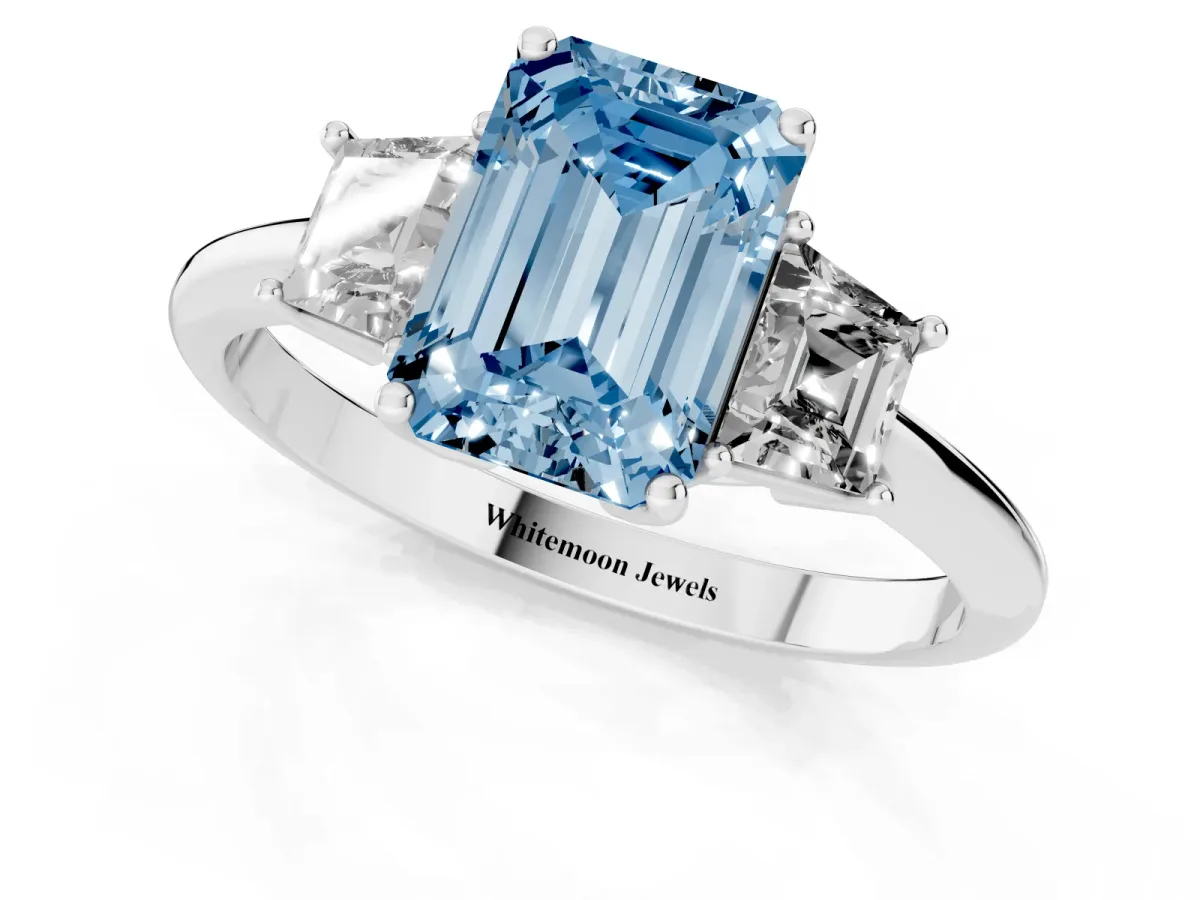Fancy Blue Emerald Cut Diamond Three-Stone Ring with Trapezoid Side Stones and Prong Setting Platinum