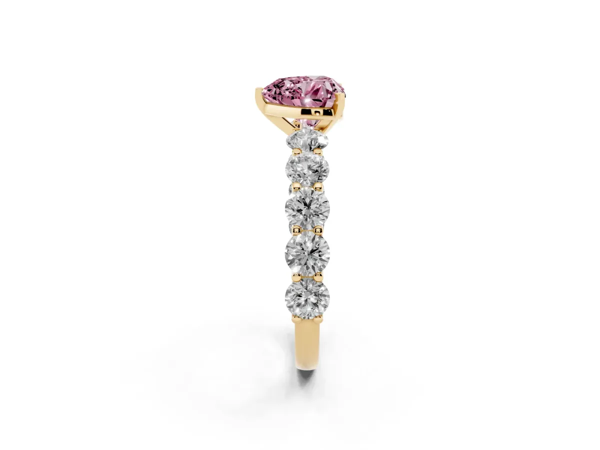 Fancy Pink Heart Cut Diamond Prong Setting with Side Stones on a Pave Band Yellow gold