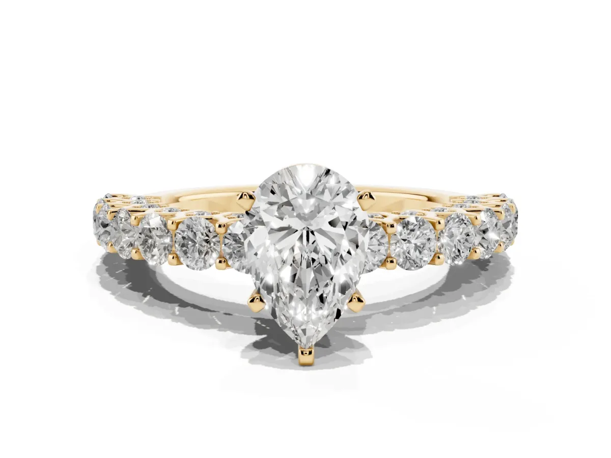 Pear Cut Diamond Solitaire Ring with Shared Prong Pavé Band and Four-Prong Setting Yellow gold