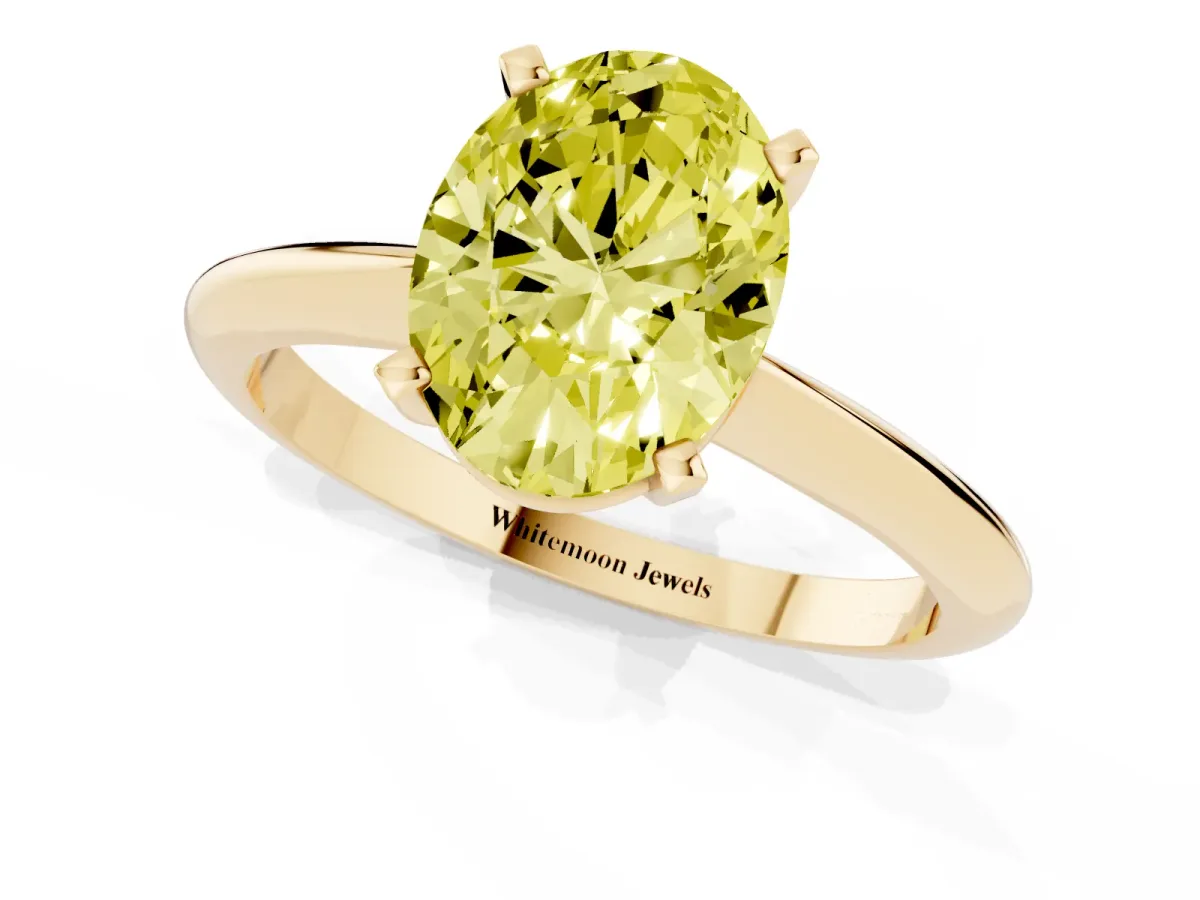 Fancy Yellow Oval Cut Cut Solitaire Ring with Four-Prong Setting on a Classic Band Yellow gold