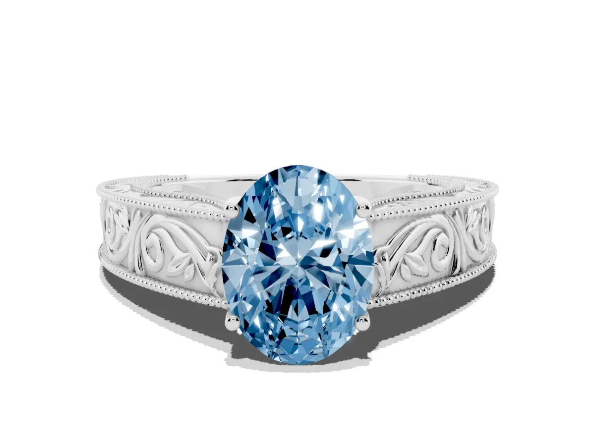Fancy Blue Oval Cut Diamond Solitaire Ring with Engraved Band and Four-Prong Setting Silver