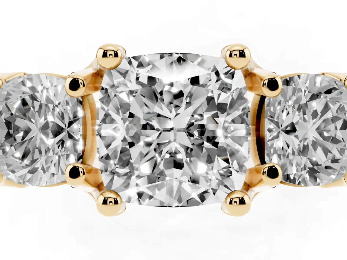 Cushion Cut Diamond Three-Stone Ring with Channel Set Band and Four-Prong Setting Yellow gold