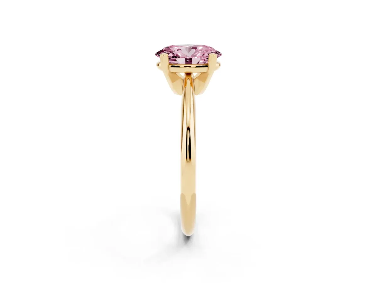 Fancy Pink Oval Cut Cut Solitaire Ring with Four-Prong Setting on a Classic Band Yellow gold