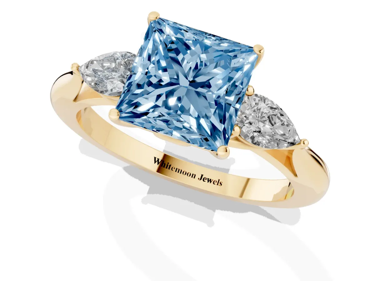 Fancy Blue Princess Cut Diamond Three-Stone Ring with Pear Side Stones and Prong Setting Yellow gold