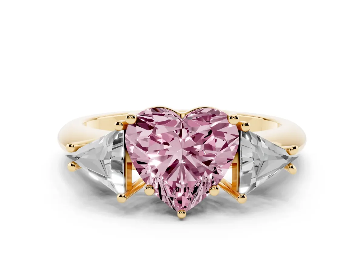 Fancy Pink Three-Stone Heart Cut Diamond Engagement Ring with Trillion Side Stones and Prong Setting Yellow gold