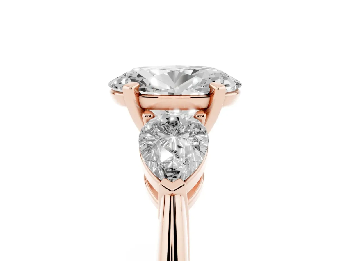 Three-Stone Oval Cut Diamond Ring with Pear Side Stones and Four-Prong Setting Rose gold
