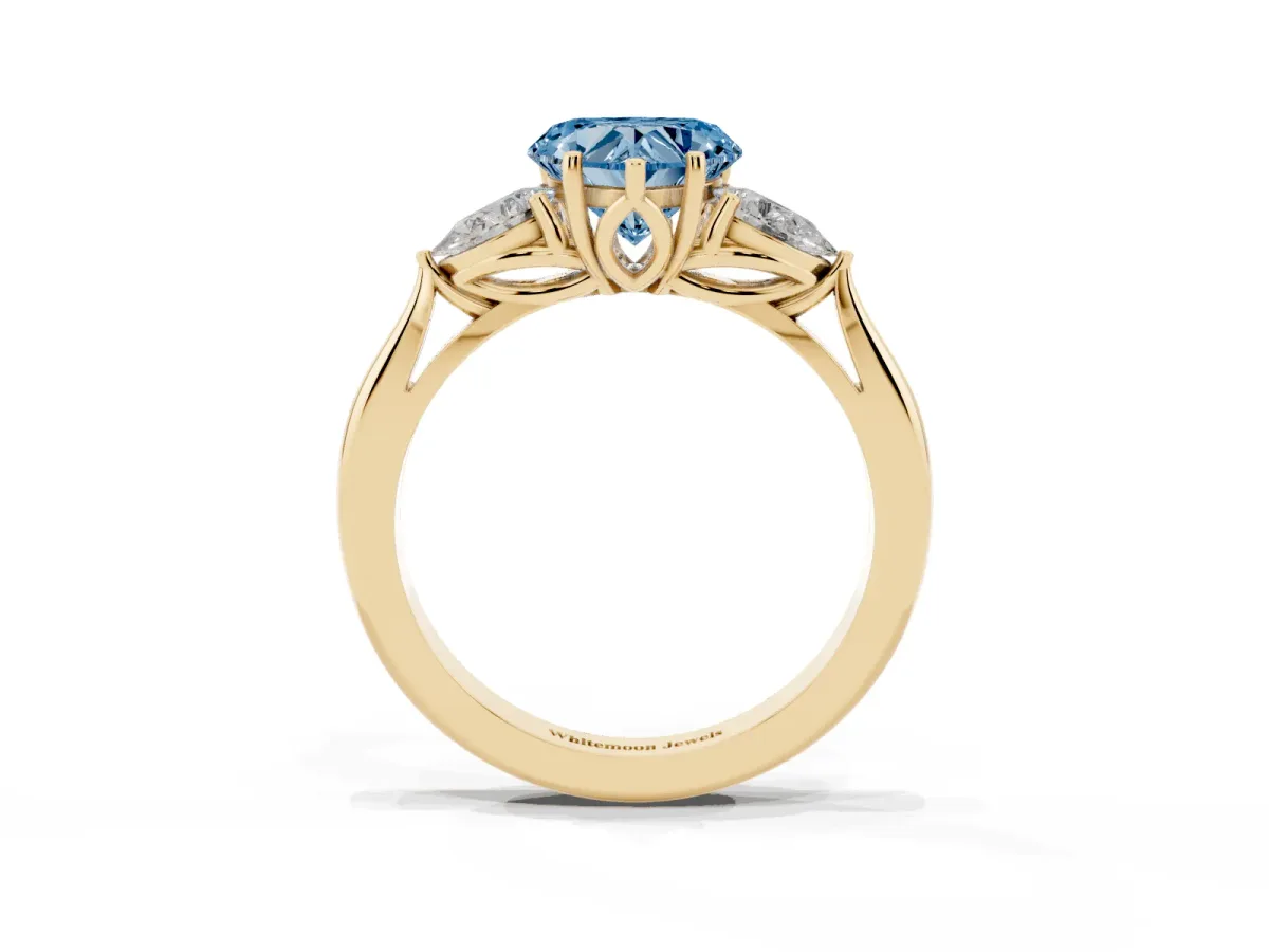 Fancy Blue Heart Cut Diamond Three-Stone Ring with Pear Side Stones and Prong Setting Yellow gold