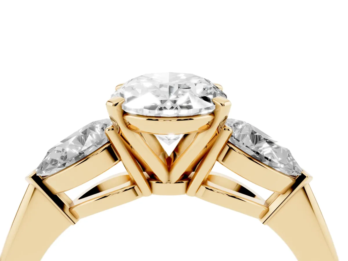 Three-Stone Oval Cut Diamond Ring with Pear Side Stones and Four-Prong Setting Yellow gold