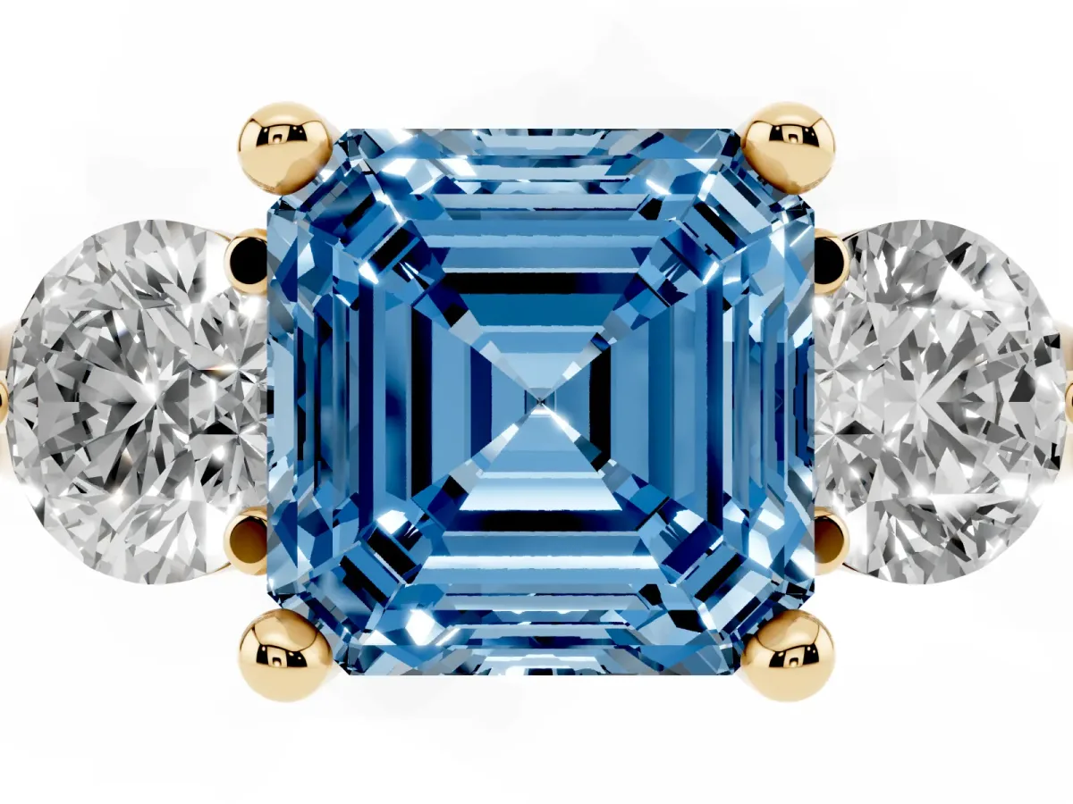 Fancy Blue Three-Stone Asscher Cut Brilliant Cut Solitaire Ring with Prong Setting on a Classic Band Yellow gold