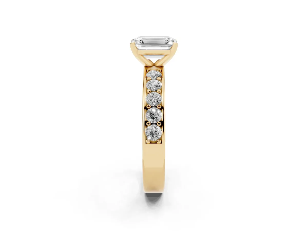 Emerald Cut Diamond Engagement Ring with Channel Set Round Band and Prong Setting Yellow gold