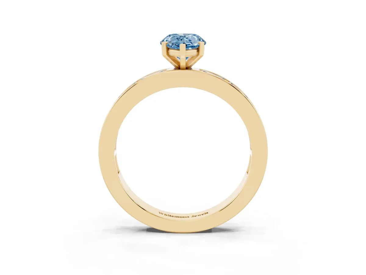 Fancy Blue Pear Cut Solitaire Diamond Ring with Channel-Set Baguette Band and Four-Prong Setting Yellow gold