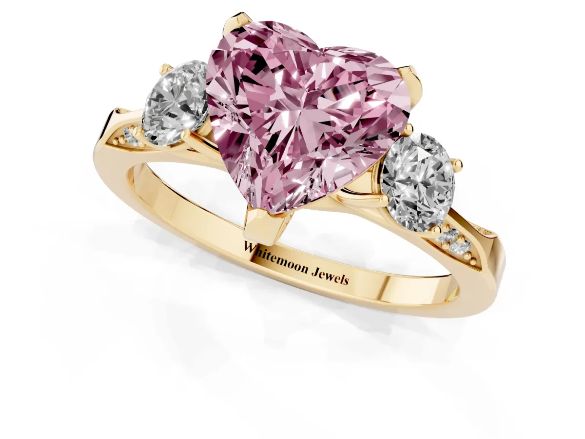 Fancy Pink Heart Cut Brilliant Three-Stone Diamond Ring with Pavé Band and Four-Prong Setting Yellow gold