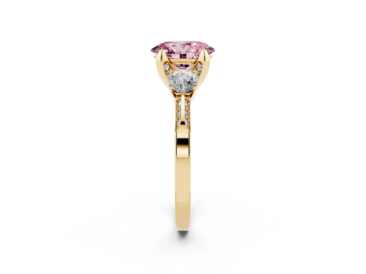 Fancy Pink Oval Cut Brilliant Three-Stone Diamond Ring with Pavé Band and Four-Prong Setting Yellow gold
