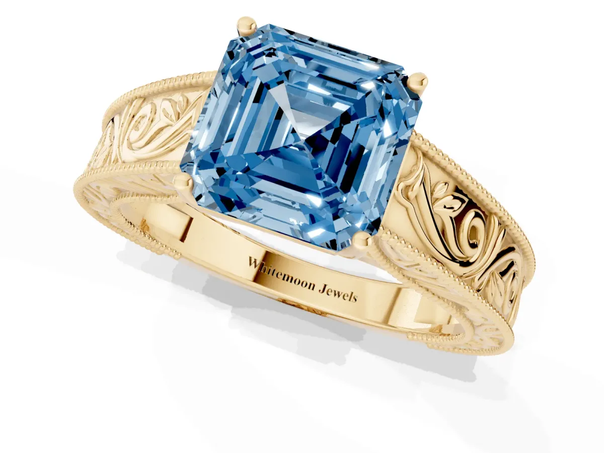 Fancy Blue Asscher Cut Diamond Solitaire Ring with Engraved Band and Four-Prong Setting Yellow gold