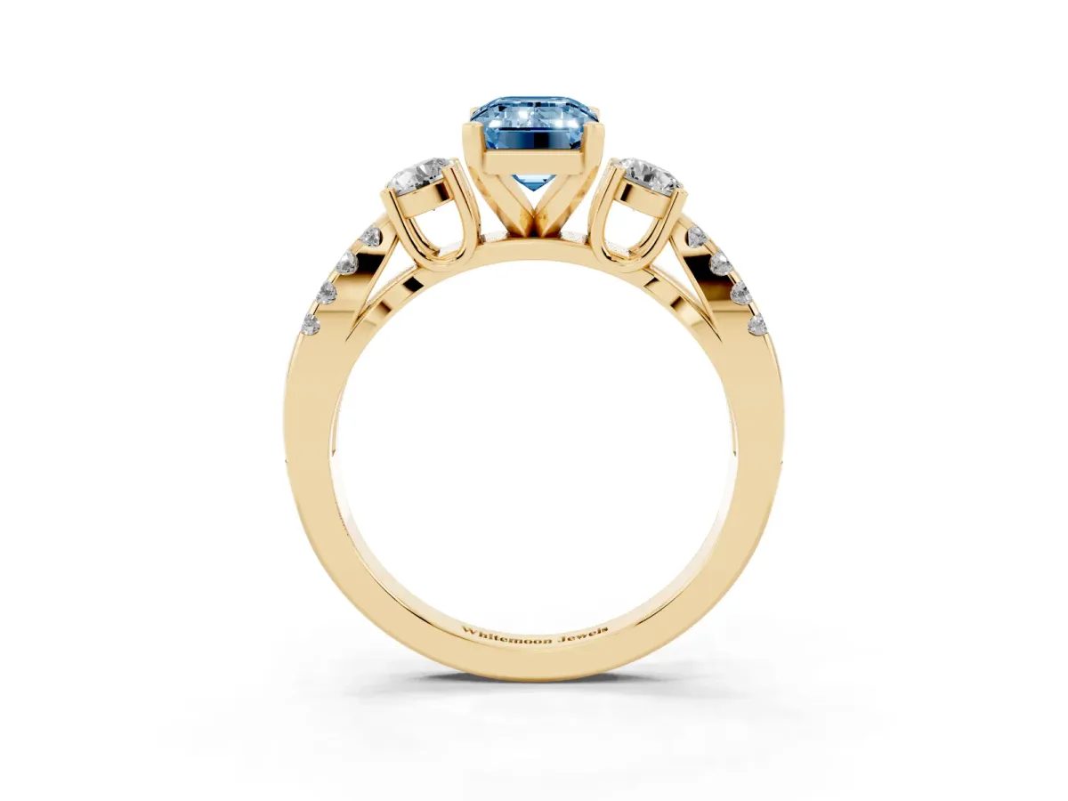 Fancy Blue Emerald Cut Diamond Three-Stone Ring with Pavé Split Shank and Four-Prong Setting Yellow gold
