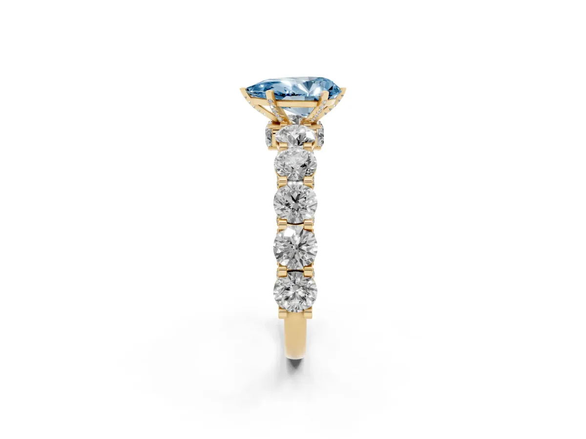 Fancy Blue Pear Cut Diamond Side Stone Engagement Ring with Four-Prong Setting Yellow gold