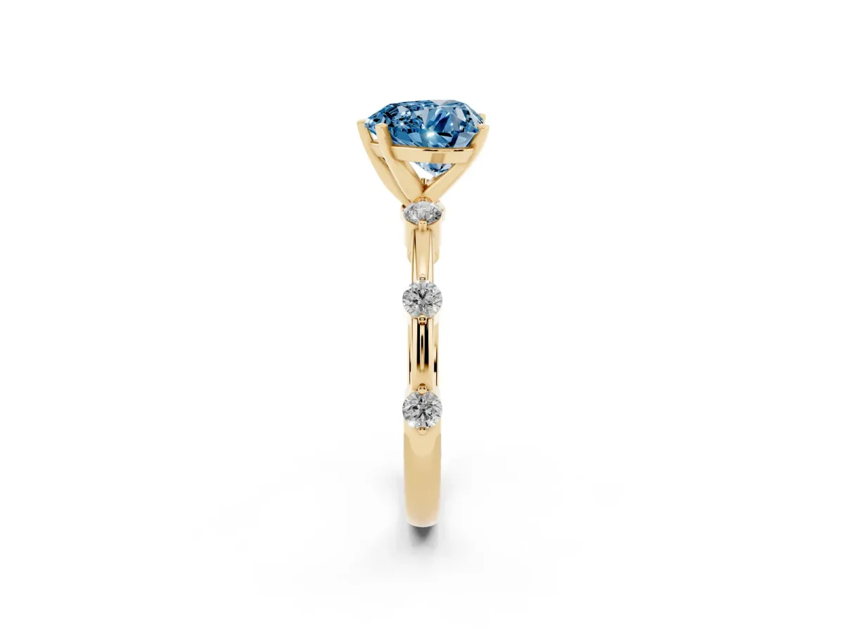 Fancy Blue Heart Cut Solitaire Diamond Ring with Bezel Set Side Stones and Prong Setting Yellow gold