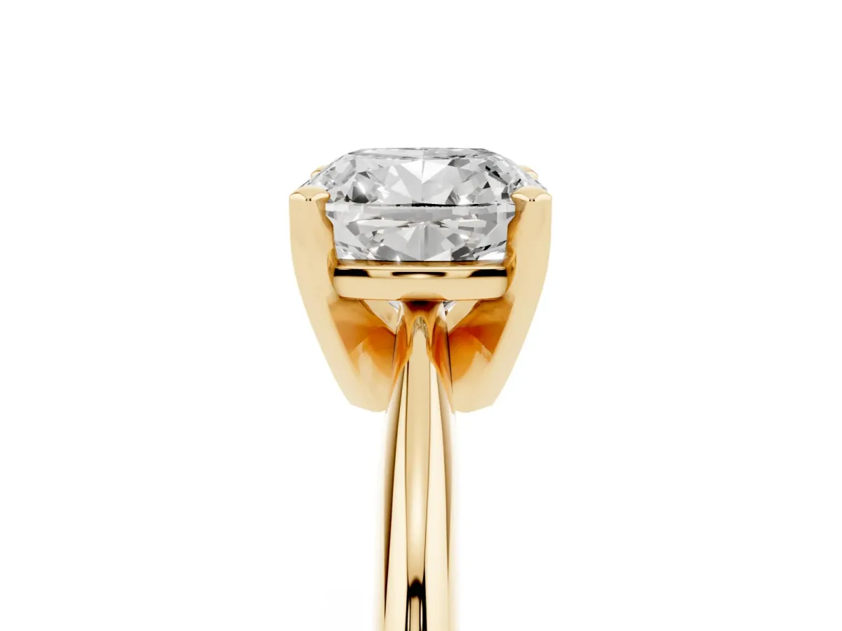 Cushion Cut Cut Solitaire Ring with Four-Prong Setting on a Classic Band Yellow gold