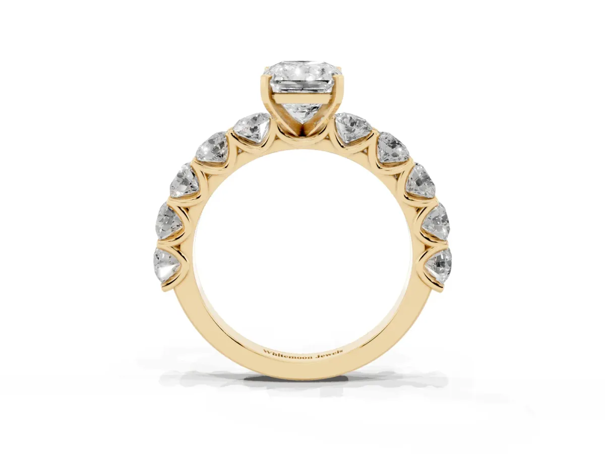 Radiant Cut Diamond Prong Setting with Side Stones on a Pave Band Yellow gold