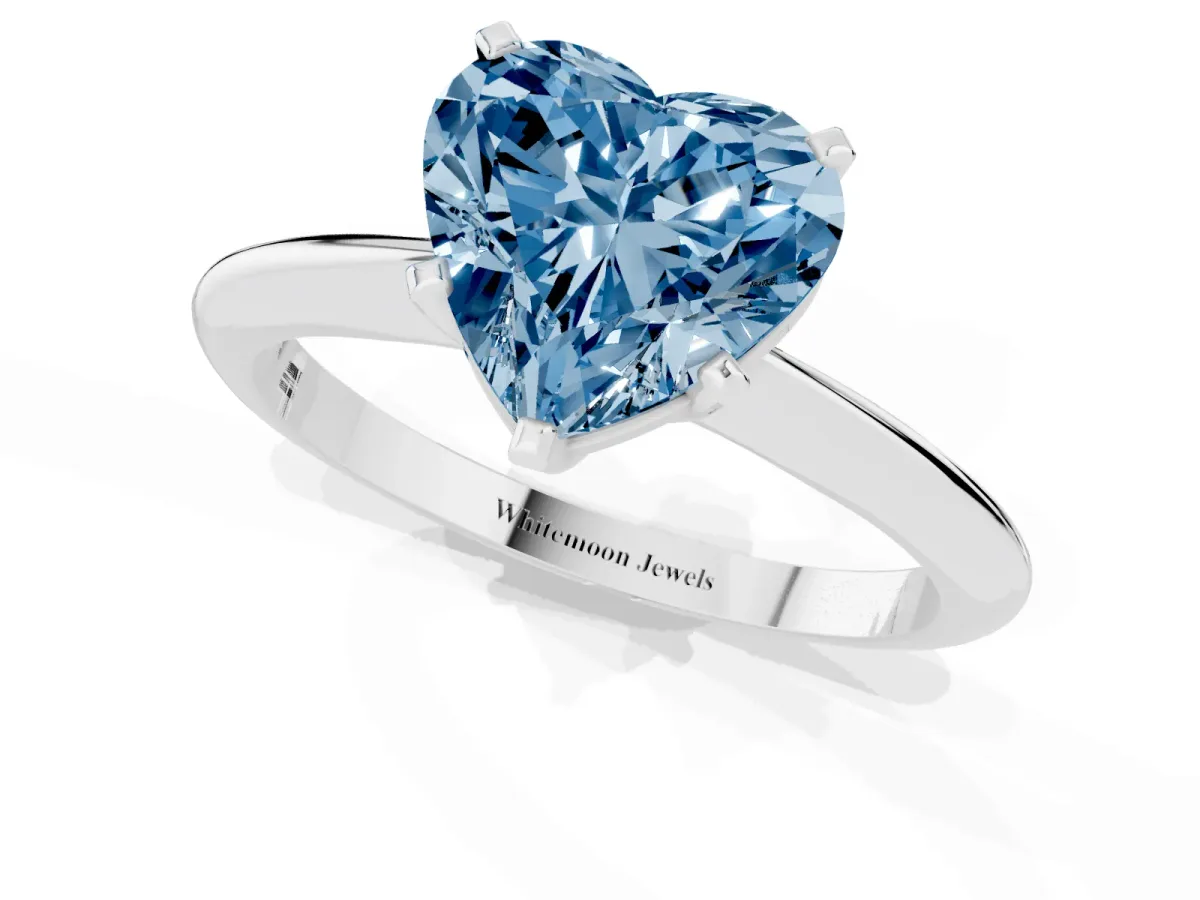 Fancy Blue Heart Cut Cut Solitaire Ring with Four-Prong Setting on a Classic Band Silver
