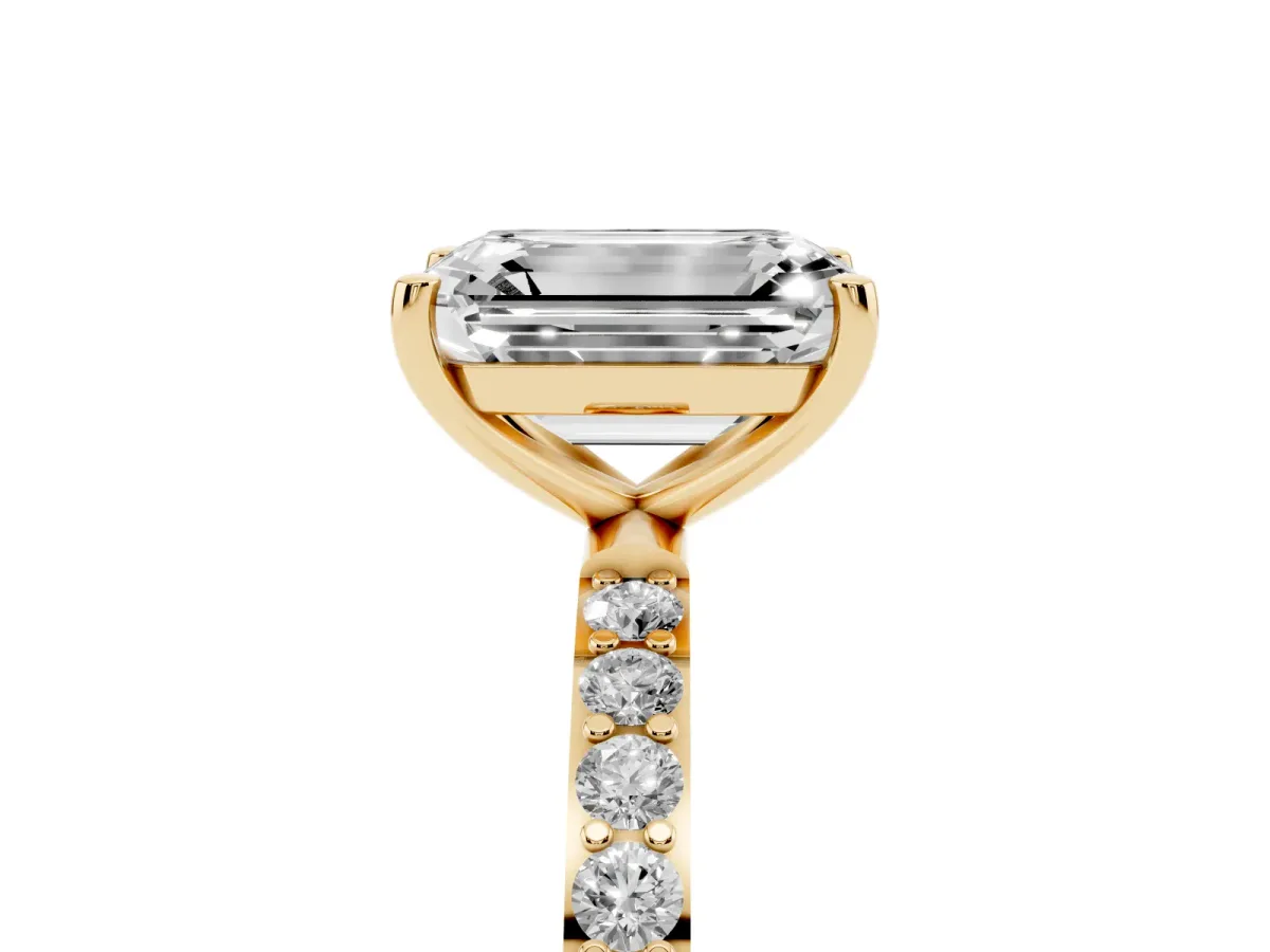 Emerald Cut Diamond Solitaire Ring with Round Pavé Shoulders and Prong Setting Yellow gold