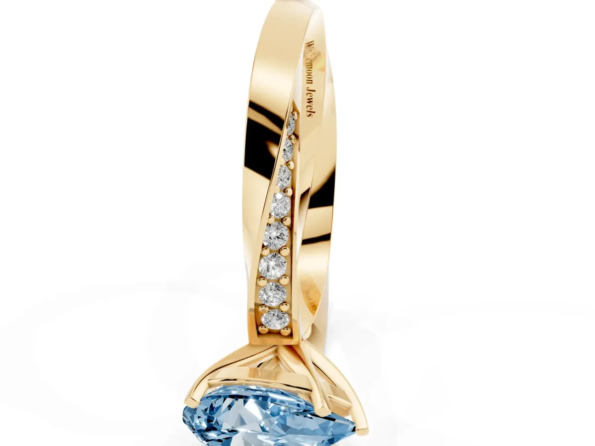 Fancy Blue Pear Cut Diamond Engagement Ring with Side Stone Accents and Four-Prong Setting Yellow gold