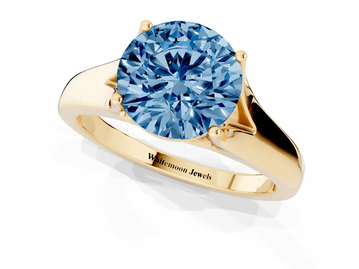 Fancy Blue Round Cut Solitaire Diamond Ring with Cathedral Band and Four-Prong Setting Yellow gold