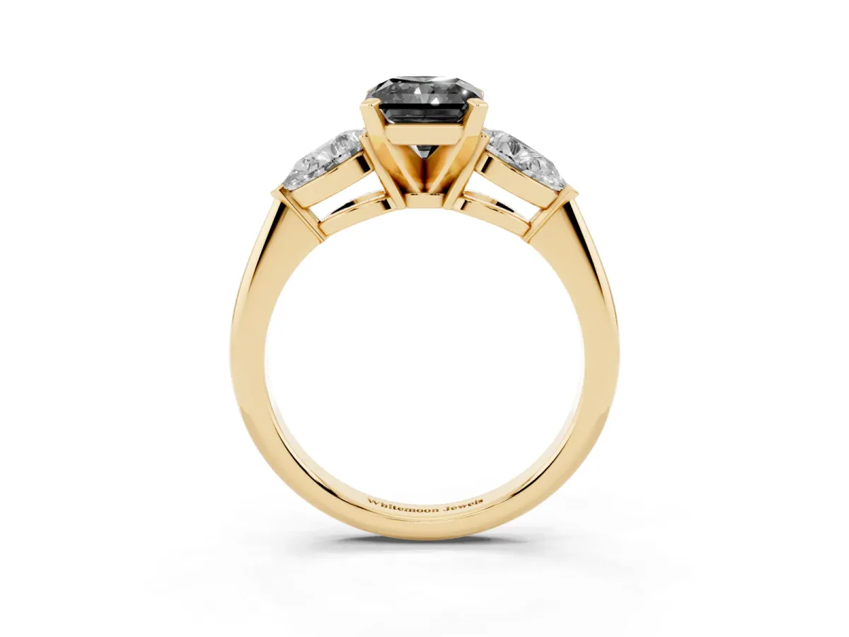 Fancy Black Three-Stone Radiant Cut Diamond Ring with Pear Side Stones and Four-Prong Setting Yellow gold