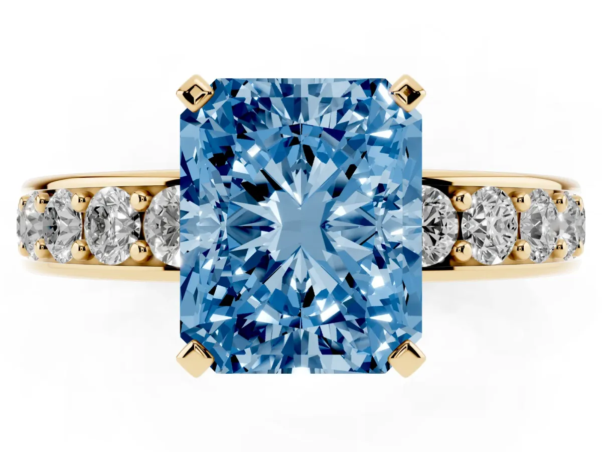 Fancy Blue Radiant Cut Diamond Engagement Ring with Channel Set Round Band and Prong Setting Yellow gold