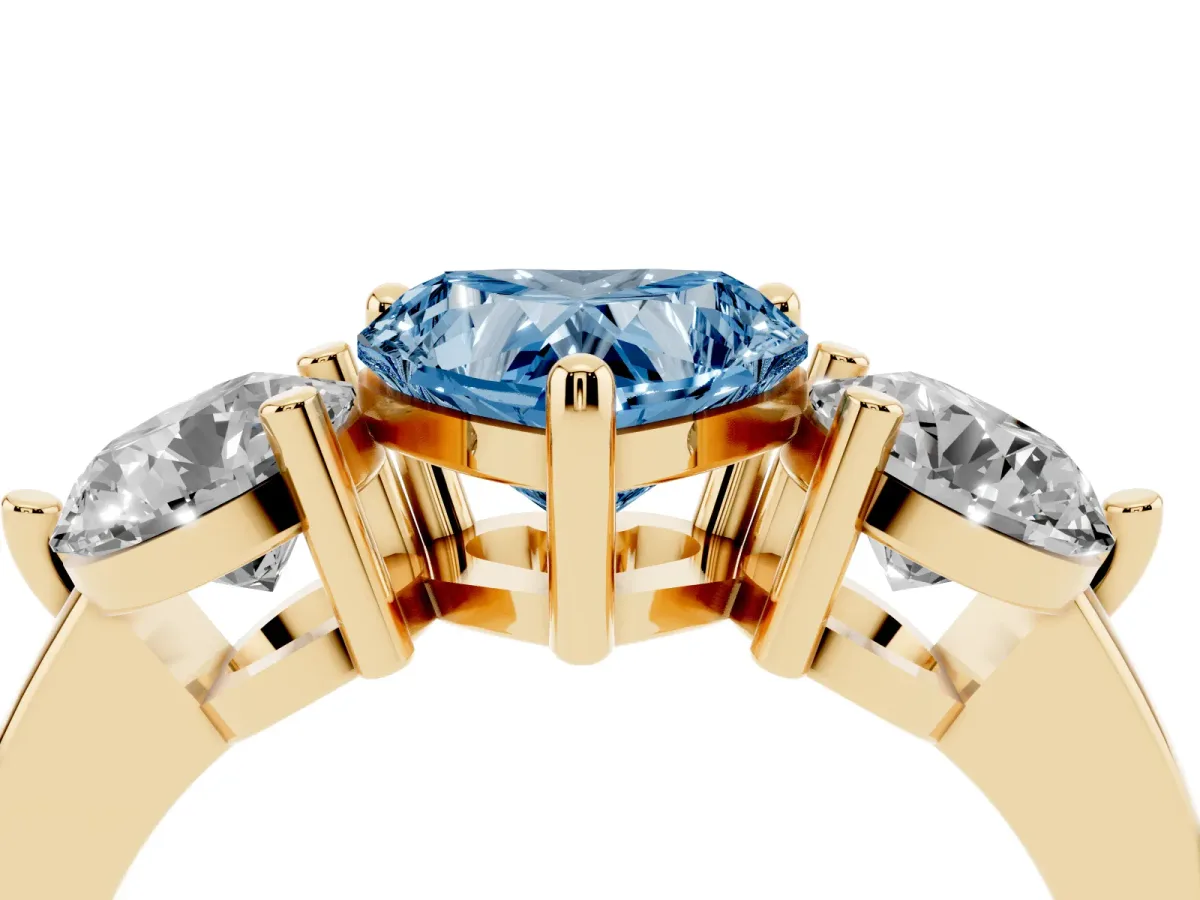 Fancy Blue Three-Stone Heart Cut Brilliant Cut Solitaire Ring with Prong Setting on a Classic Band Yellow gold