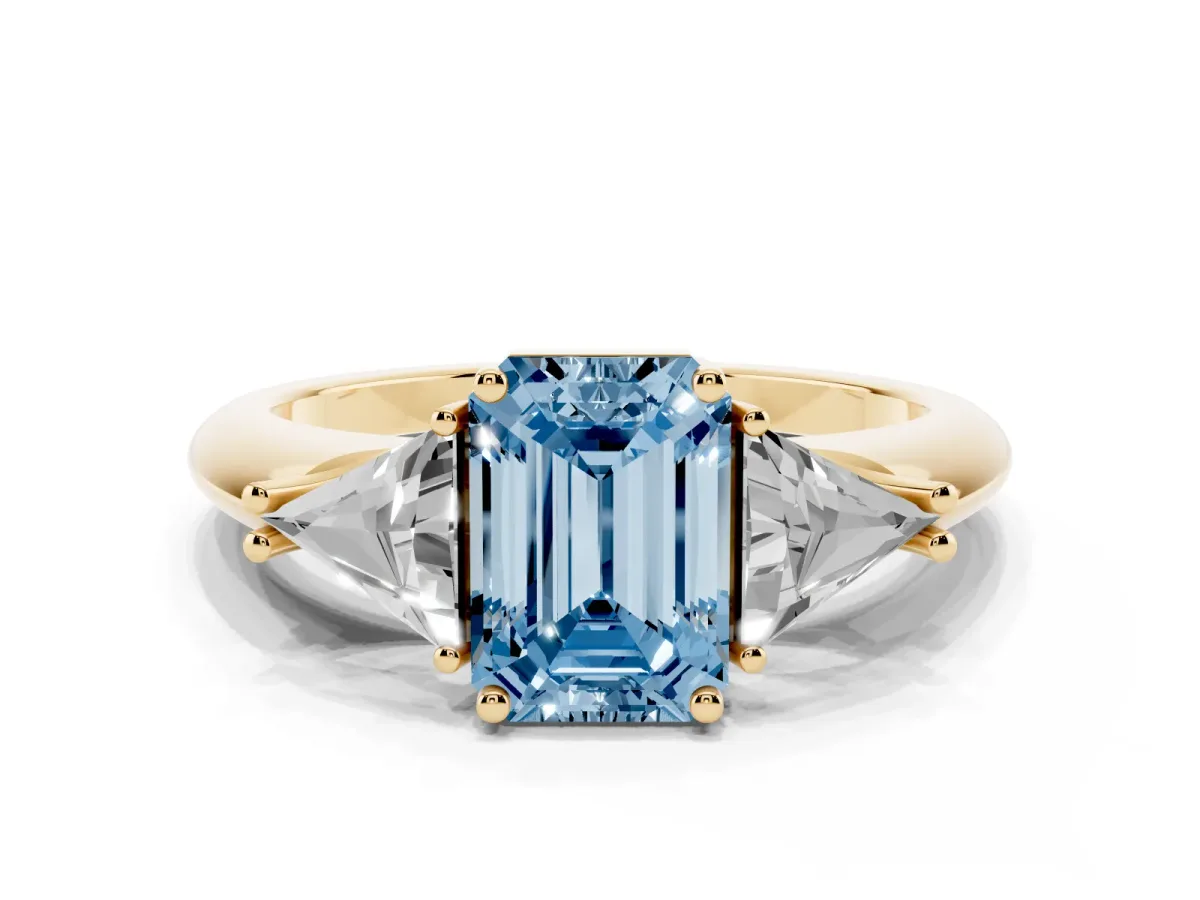 Fancy Blue Three-Stone Emerald Cut Diamond Engagement Ring with Trillion Side Stones and Prong Setting Yellow gold