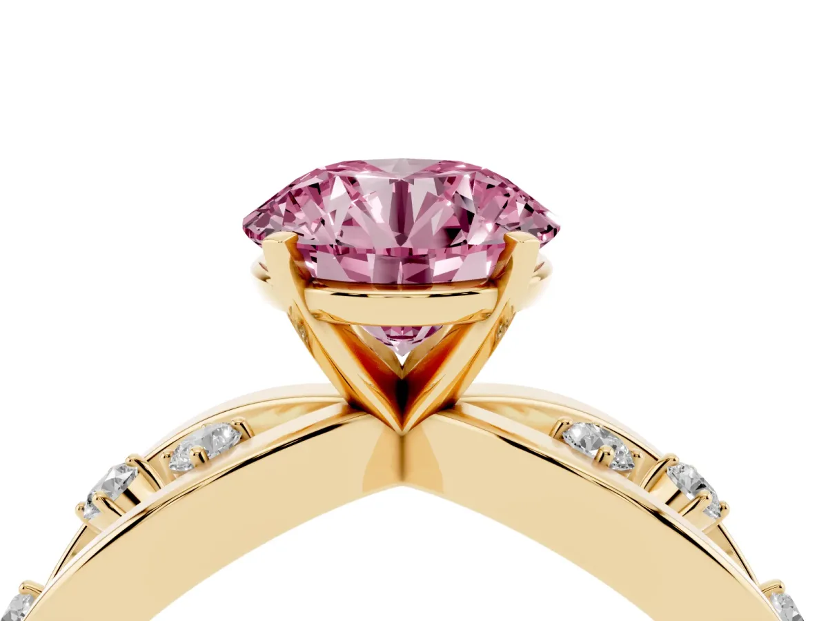 Fancy Pink Round Cut Cut Solitaire Diamond with Side Stones on Criss-Cross Band and Four-Prong Setting Yellow gold