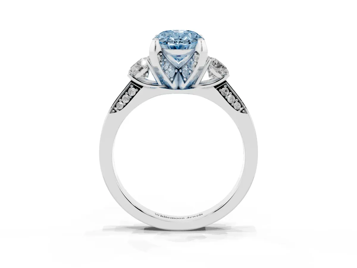 Fancy Blue Oval Cut Brilliant Three-Stone Diamond Ring with Pavé Band and Four-Prong Setting White gold