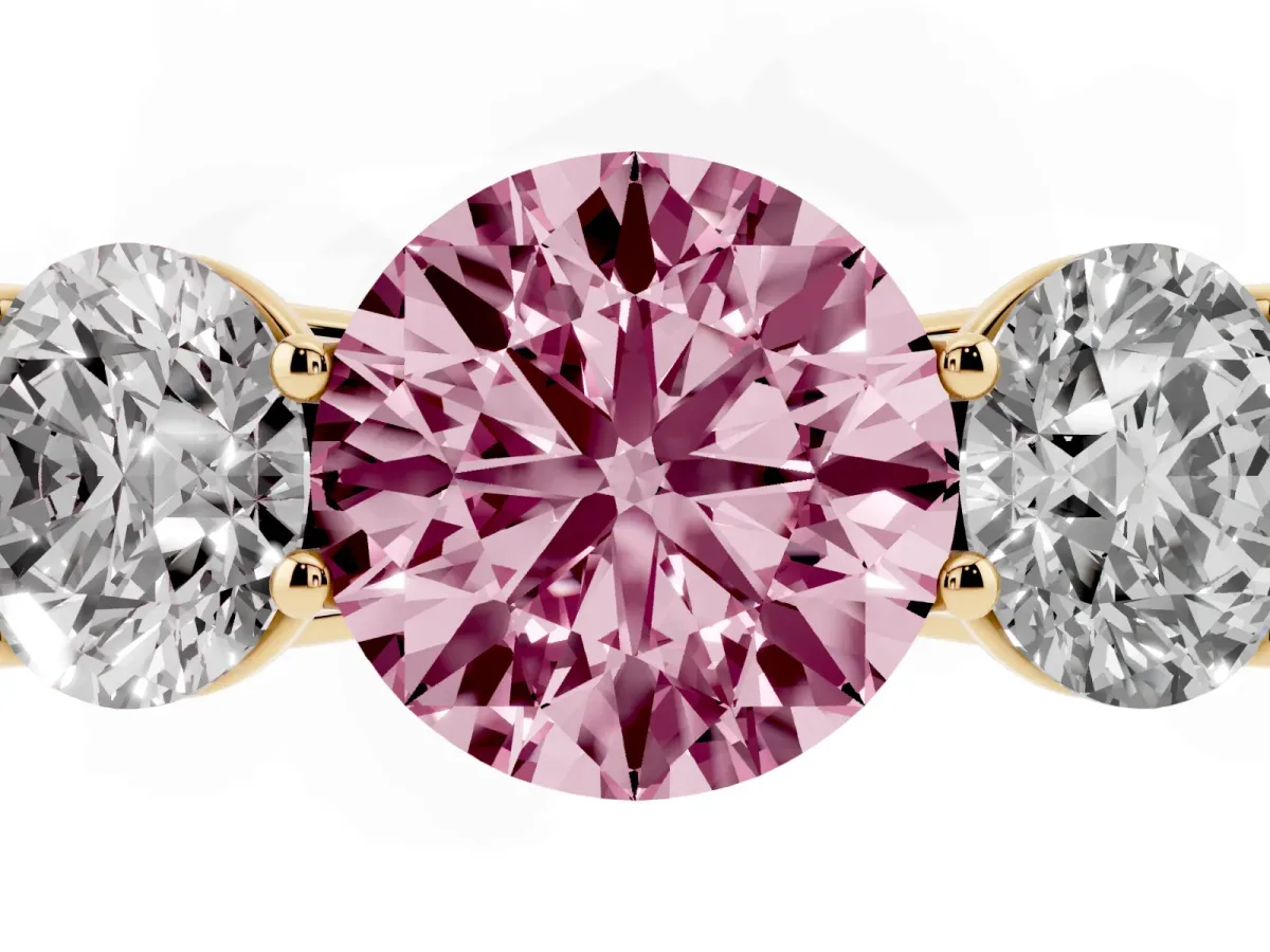 Fancy Pink Round Cut Three-Stone Diamond Ring with Prong Setting on a Classic Band Yellow gold