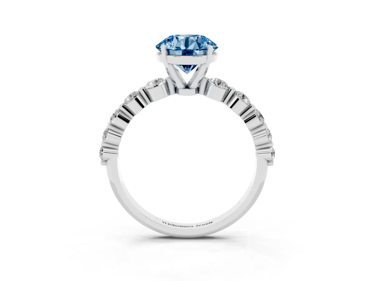 Fancy Blue Round Cut Solitaire Diamond Ring with Pave Band and Four-Prong Setting Silver