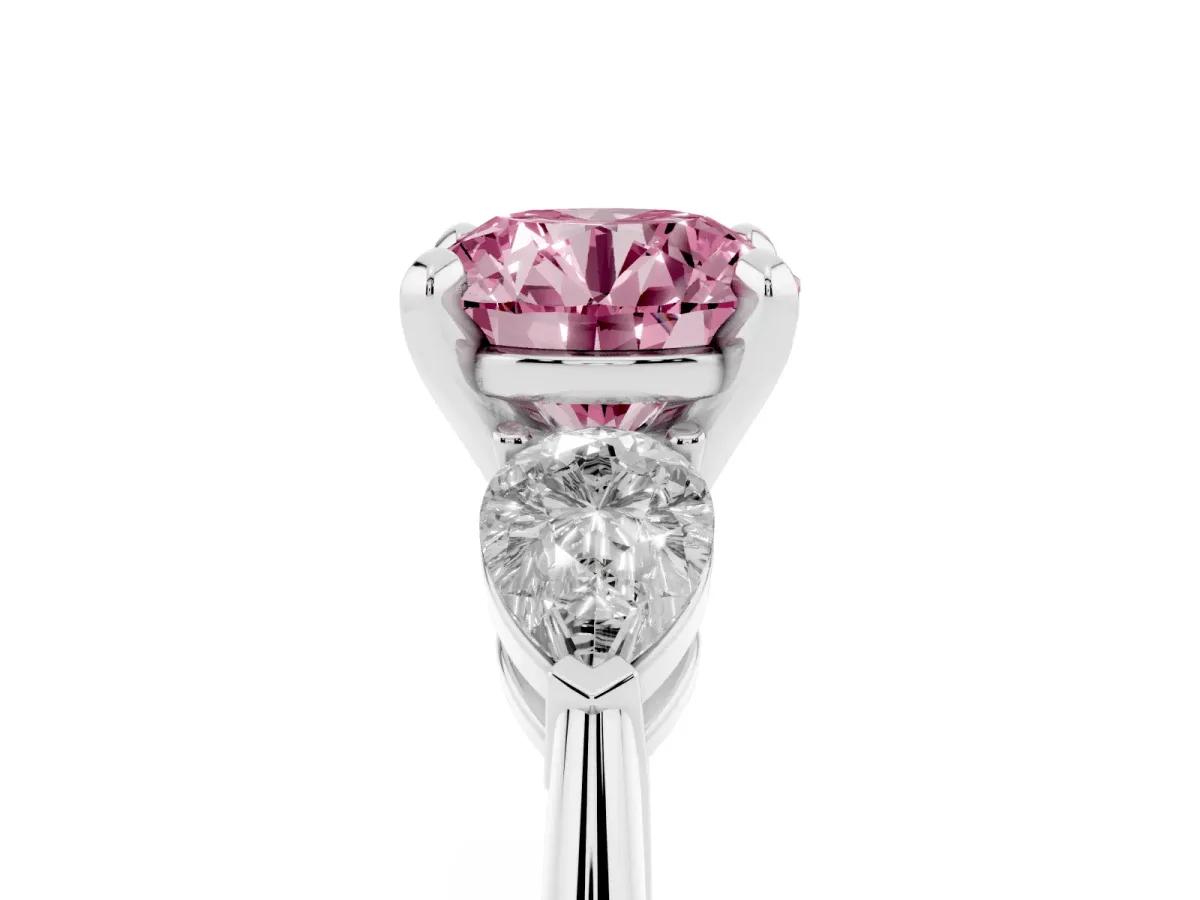 Fancy Pink Three-Stone Round Cut Diamond Ring with Pear Side Stones and Four-Prong Setting Platinum