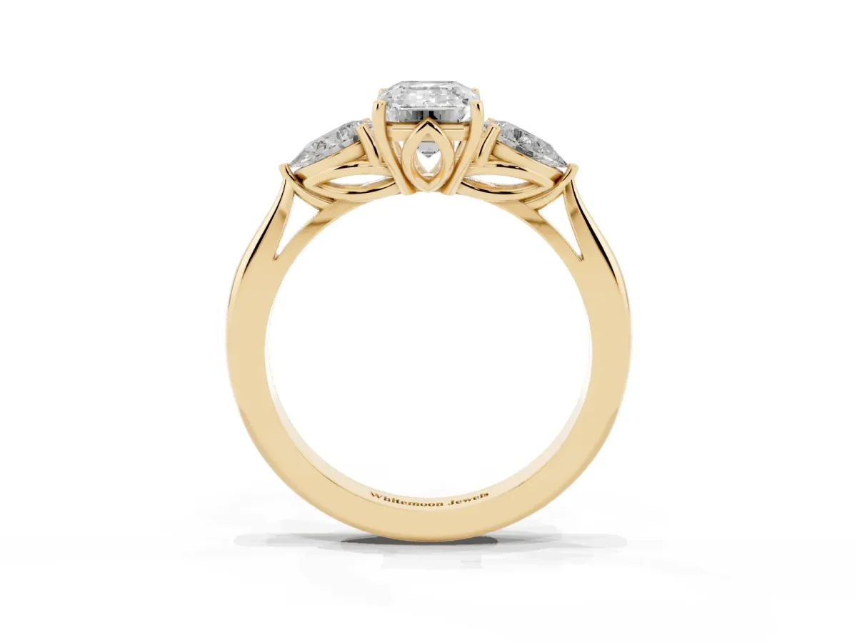 Three-Stone Emerald Cut Diamond Ring with Pear Side Stones in Four-Prong Setting Yellow gold