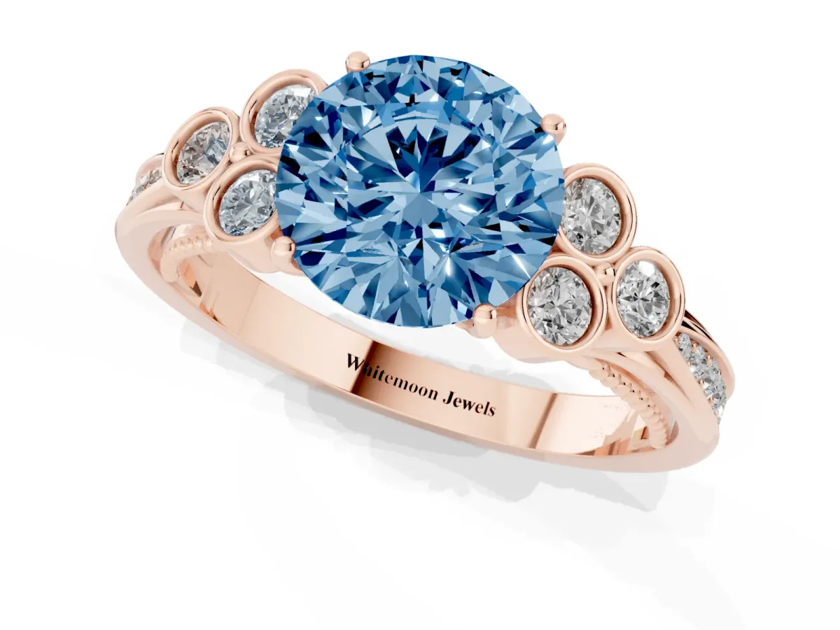 Fancy Blue Round Cut Cut Diamond Engagement Ring with Bezel Set Round Side Stones and Prong Setting Rose gold