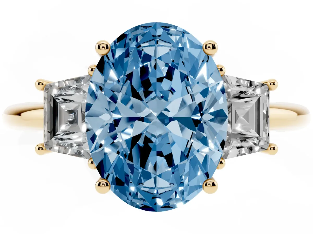 Fancy Blue Oval Cut Diamond Three-Stone Ring with Trapezoid Side Stones and Prong Setting Yellow gold
