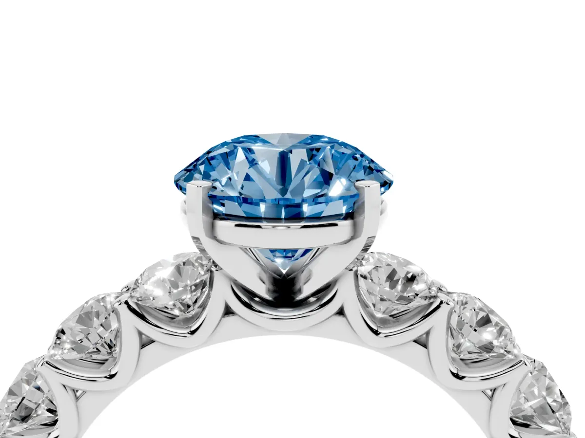 Fancy Blue Round Cut Diamond Prong Setting with Side Stones on a Pave Band Silver