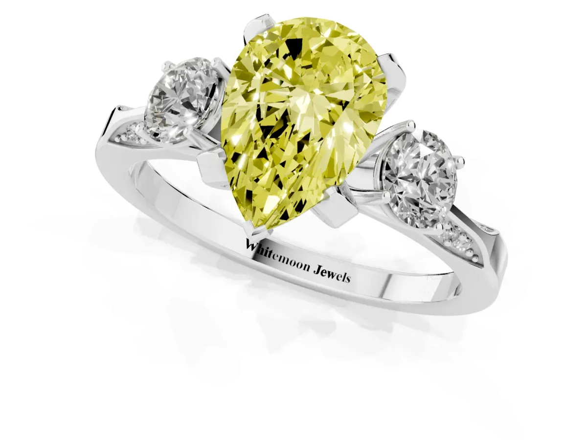 Fancy Yellow Pear Cut Brilliant Three-Stone Diamond Ring with Pavé Band and Four-Prong Setting Platinum