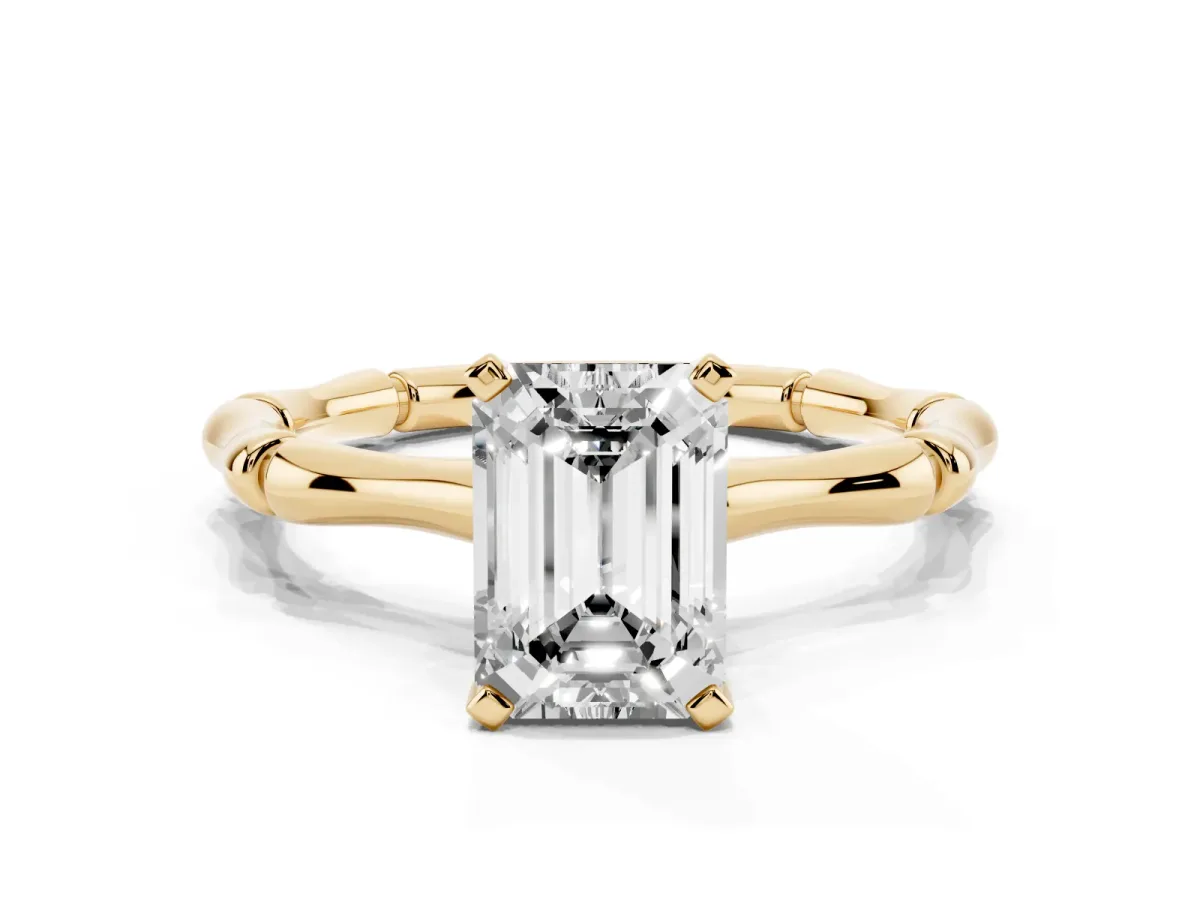 Emerald Cut Solitaire Diamond Ring with Bamboo Band and Four-Prong Setting Yellow gold