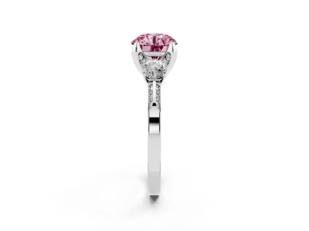 Fancy Pink Round Cut Brilliant Three-Stone Diamond Ring with Pavé Band and Four-Prong Setting White gold