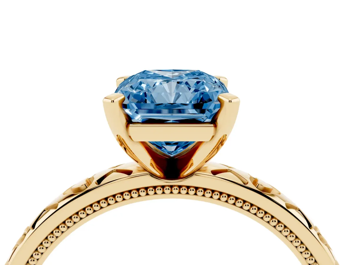 Fancy Blue Radiant Cut Solitaire Diamond Engagement Ring with XO Engraved Band and Four-Prong Setting Yellow gold